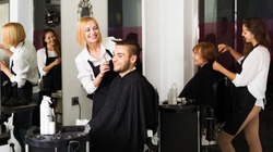Hairdresser makes the cut for man in the hairdressing salon