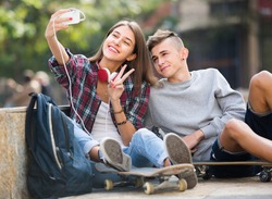 teenagers taking picture of themselves for selfie with phone