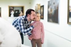 Ordinary father and daughter exploring religious art in museum