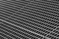 Iron gutter grates and metal vent grids as black and white industrial background
