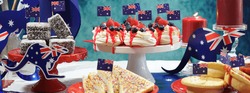 Australian theme party table with flags and iconic food including mini pavlovas, lamingtons, meat pies and fairy bread, sized to fit a popular social media cover image placeholder.
