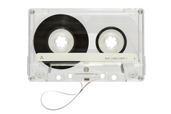 Vintage audio cassette tape with transparent plastic case and black tape on reels isolated on white background in light studio