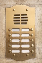 Brass intercom on a marble facade