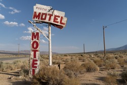 Abandoned generic rustic motel sign is falling apart and decaying in the California desert, near Olancha, CA