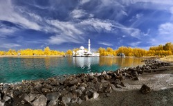 Beautiful mosque by the lakeside viewed in infrared