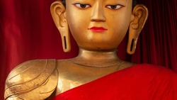 Bronze buddha statue with red robes