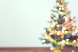 blur light celebration on christmas tree with white wall background