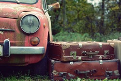 Nice old car and suitcase in with retro effect