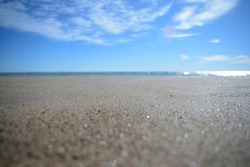 a view of the horizon from the beach at ground level