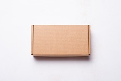 Cardboard, carton mailer box, case, top view on white wooden bac