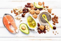 Selection food sources of omega 3 and unsaturated fats. Super foods high vitamin e and dietary fiber for healthy food on wooden background.