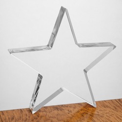 Blank acrylic block ready for engraving, star shape, on wooden table