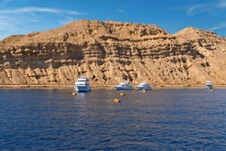 Yachts in sea port of Sharm El-Sheikh, rock mountain view, Egypt, South Sinai