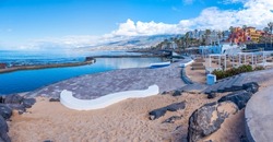 Sun Lounges at Playa de las americas at Tenerife, Canary islands, Spain.