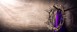 Crown Of Thorns And Purple Robe Hanging On Nail In Stone Wall With Light Rays
 - Crucifixion Of Jesus Christ