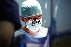 Unrecognizable surgeon performing operation, operation theater, surgery
