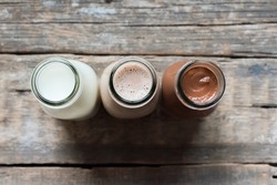 Three Different Sorts Beverage Milk Cocoa Chocolate Bottle Wooden Background Top View