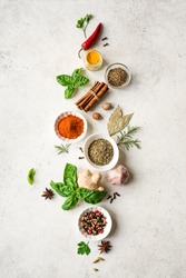 Various Spices, Herbs and Condiments on white stone table, top view, copy space. Healthy cooking, indian food background.