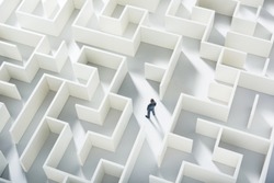 Business challenge. A businessman navigating through a maze. Top view