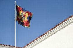 Romanian royal heraldry is seen on the royal flag photographed against blue sky