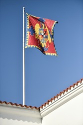 Romanian royal heraldry is seen on the royal flag photographed against blue sky