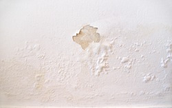 Rain water leaks on the wall causing damage and peeling paint