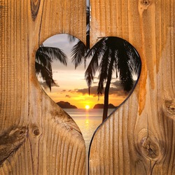 Beach sunset in a wooden heart frame