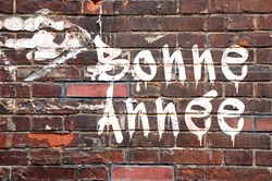 Bonne annee, meaning Happy new Year in French, on a brick wall, street-art style