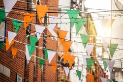 Garland with irish flag colors in a street of Dublin, Ireland - Saint Patrick day celebration concept