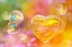 Soap bubble in the shape of a heart, colorful background