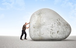 man try to move an huge stone