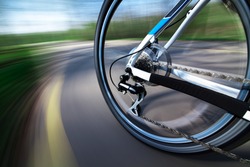 View of rear bicycle wheel with chain and cassette in motion