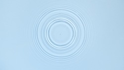 Circles on water surface on pale blue background | Background shot for skin care cosmetics commercial