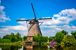 Traditional Dutch windmill at Kinderdijk on a sunny summer day. Kinderdijk windmills are a UNESCO world heritage site in the Netherlands.