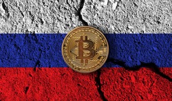 Bitcoin crypto currency coin with cracked Russia flag. Crypto restrictions