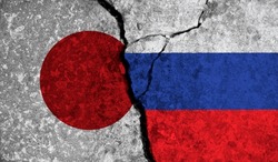 Political relationship between Japan and russia. National flags on cracked concrete background