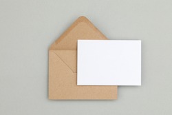Blank white card with kraft brown paper envelope template mock up