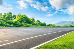 Asphalt road and green tea mountain nature landscape on sunny day.