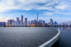 Panoramic skyline and modern commercial buildings with empty circular square in Beijing, China.