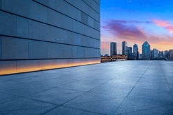 Empty square floor and wall building with city skyline in Shanghai at night, China.