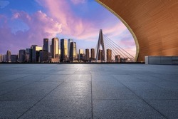 Empty floor and city skyline with modern buildings at sunrise in Chongqing, China.