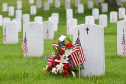 National flags and headstones in Arlington National cemetery - Washington DC, United States of America