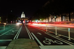 Washington DC, United States Capitol building night view from from Pennsylvania Avenue with car lights trails 