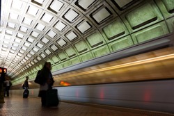 Subway station with passengers and train in motion blur - Washington DC, United States
