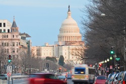 Capitol building from Pennsylvania Avenue with car traffic foreground - Washington DC United States