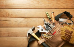 tools in tool belt on wood planks with copy space