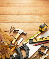 variety of carpentry tools on wood planks with copy space