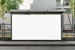 Large empty commercial banner mounted on urban bus stop front view outdoor