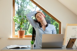 Beautiful women performing exercises and stretching in front of a laptop. Working at home, health concept.