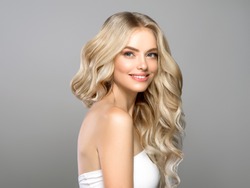 Beautiful blonde hair woman long curly hairstyle healthy skin natural makeup